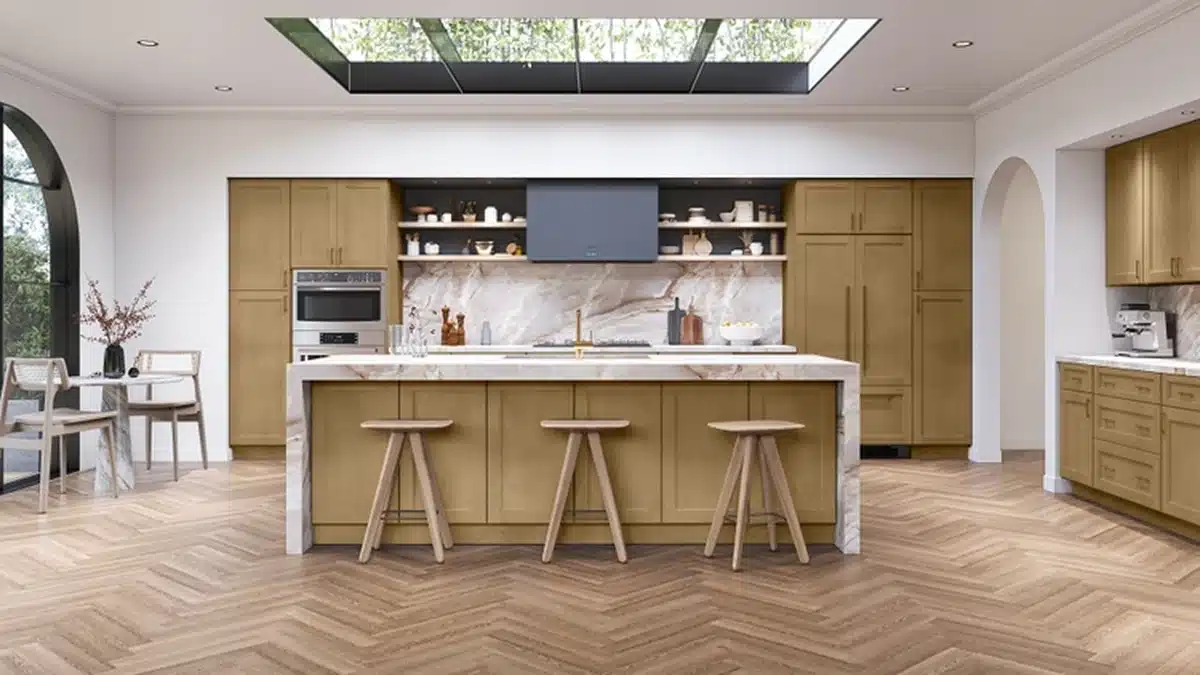 The same rendered kitchen with the shaker cabinets in a mid tone wood finish: tall pantry units around a built in wall oven, open shelving over a veined marble backsplash, an island with a waterfall edge marble top and three wooden stools, and herringbone wood floors under a skylight.