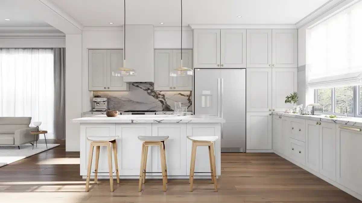 Rendered open plan kitchen with white wide shaker cabinets, tall cabinets surrounding a stainless steel refrigerator, an island with three wooden stools, a boldly veined dark marble backsplash behind the cooktop, two glass pendant lights and wood floors, with a living area to the left.