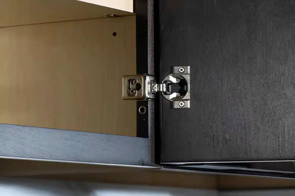 Blum Compact Clip hinge mounted on the face frame of a dark-finish Fabuwood cabinet