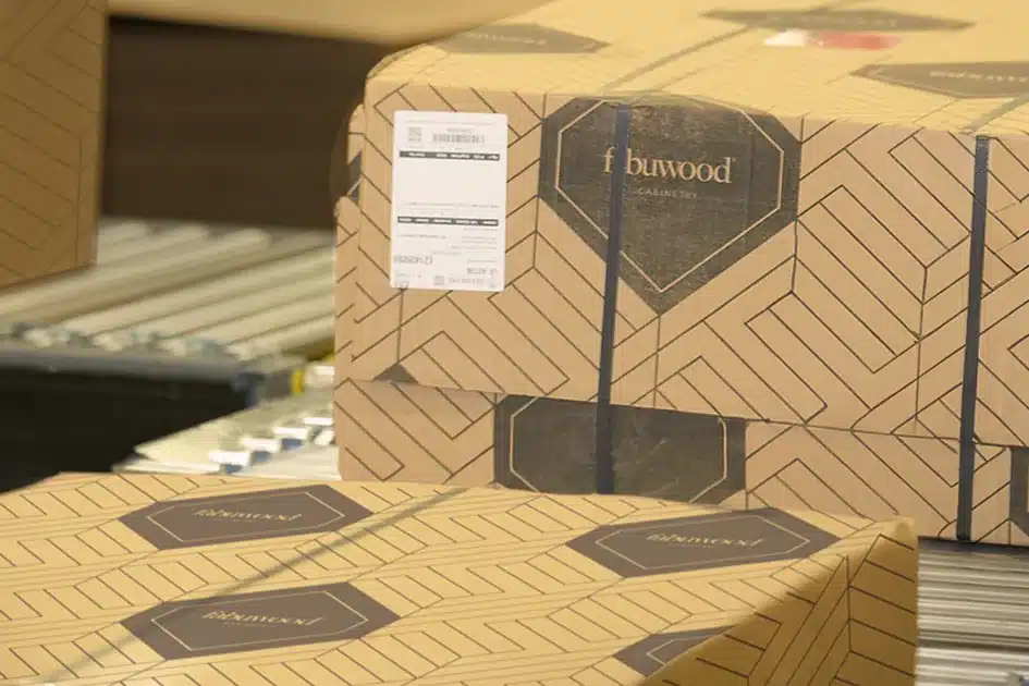 Stacked Fabuwood shipping cartons with order labels in a warehouse